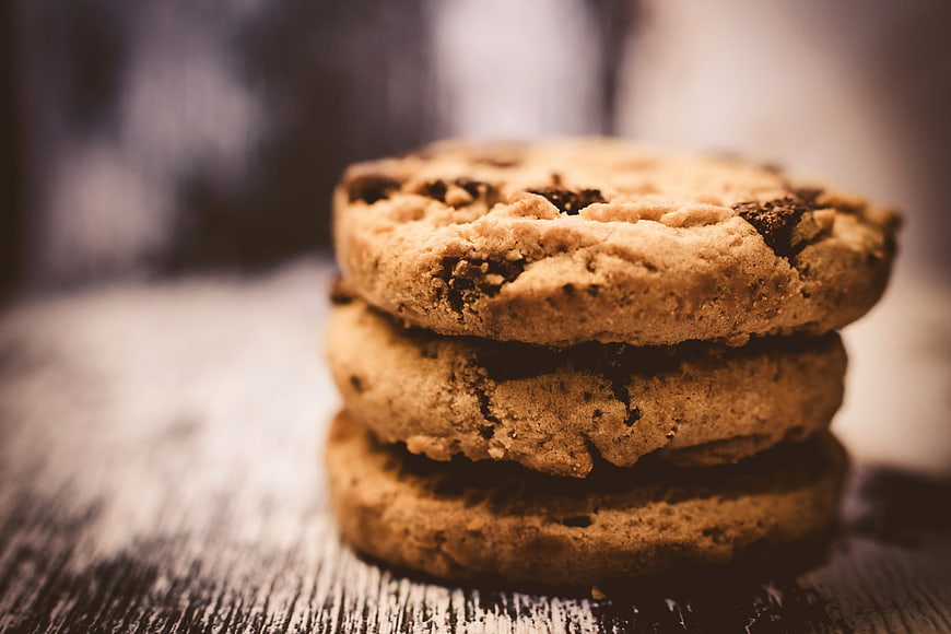 Stack of chocolate chip cookies on rustic wooden table