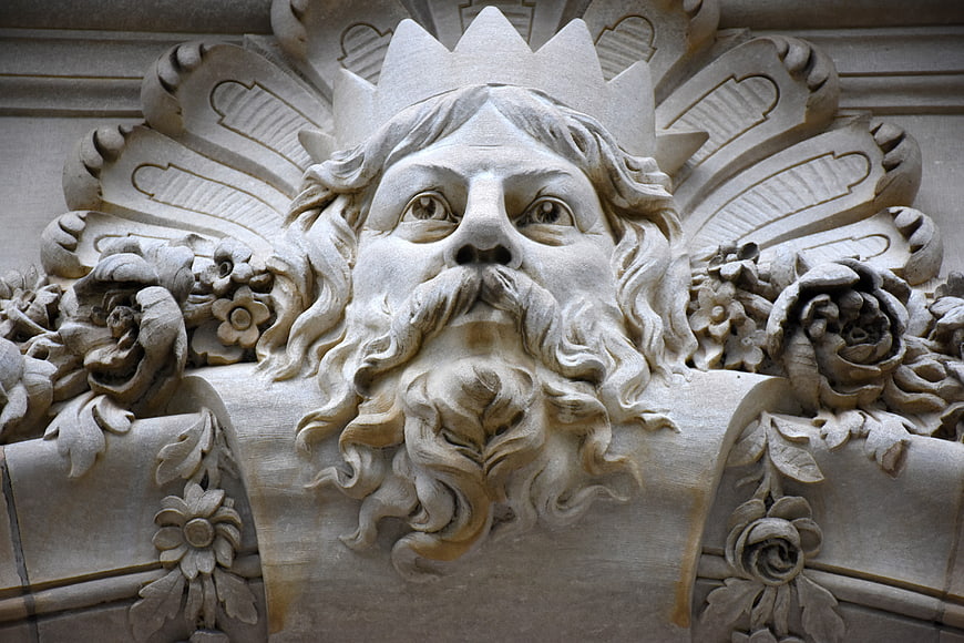 Detailed Stone Relief Sculpture of a Mythological King with Crown