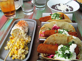 Mexican Food Spread With Tacos And Elote On Rustic Table