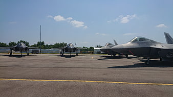 F-35 Lightning II fighter jets parked on airfield tarmac
