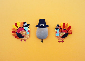 Cute felt turkey and pilgrim rock crafts on yellow background