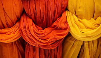 Vibrant Orange and Yellow Draped Fabric Texture Close Up