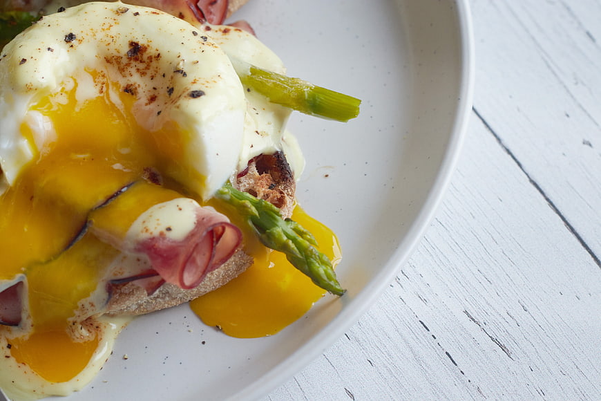 Close-up of Eggs Benedict with Asparagus and Runny Yolk
