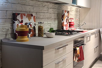 Modern kitchen interior with light wood cabinets and stone backsplash
