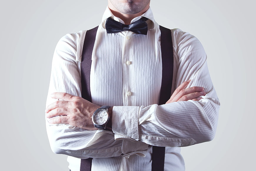 Man in Bow Tie and Suspenders with Crossed Arms
