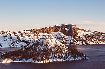 Aerial View of Snowy Mountain Island in Lake at Sunset