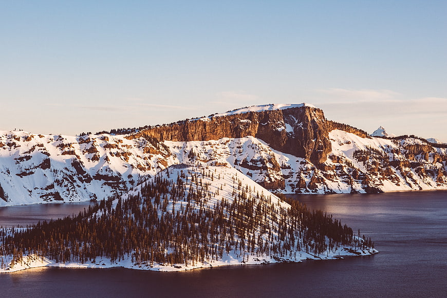 Aerial View of Snowy Mountain Island in Lake at Sunset