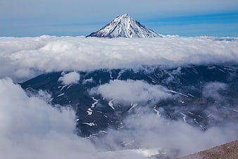 Majestic Snow-Capped Mountain Peak Rising Above Sea of Clouds
