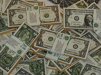 Stacks of One Dollar Bills Scattered on Surface