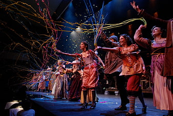 Theatrical performance with colorful streamers and confetti