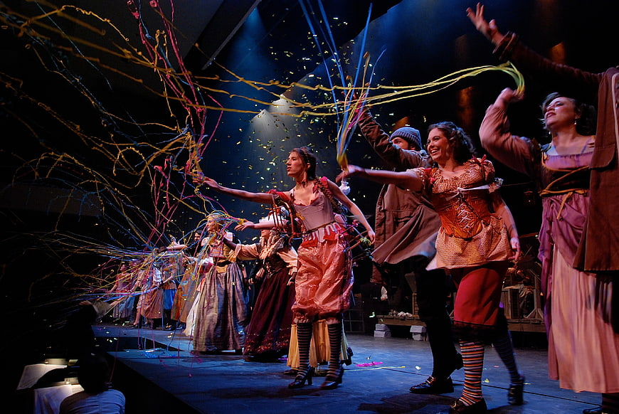 Theatrical performance with colorful streamers and confetti