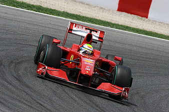 Red Ferrari Formula 1 Race Car Cornering on Track