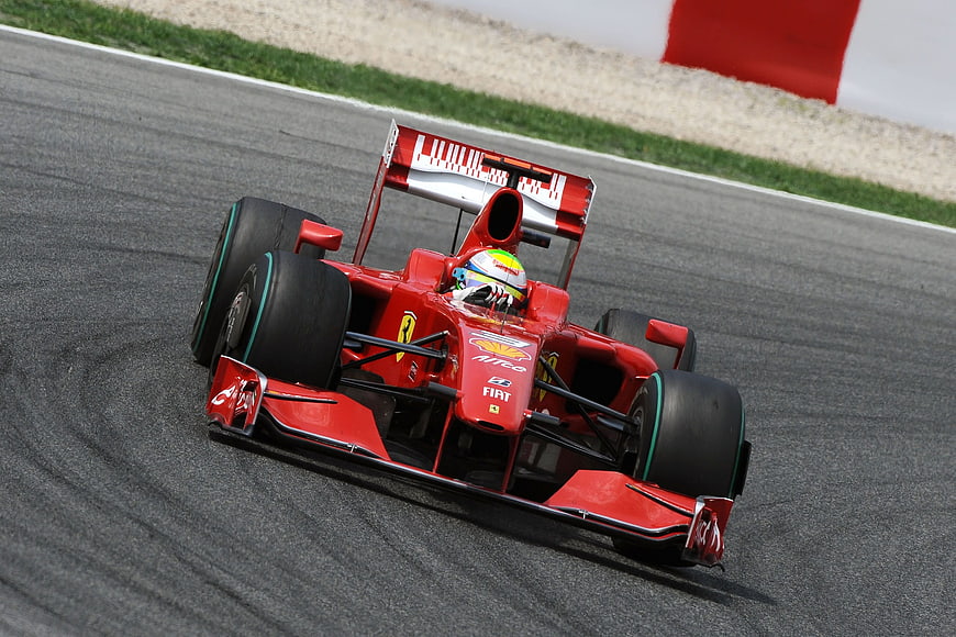 Red Ferrari Formula 1 Race Car Cornering on Track