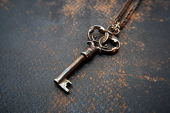 Vintage Skeleton Key Pendant Necklace on Rustic Background