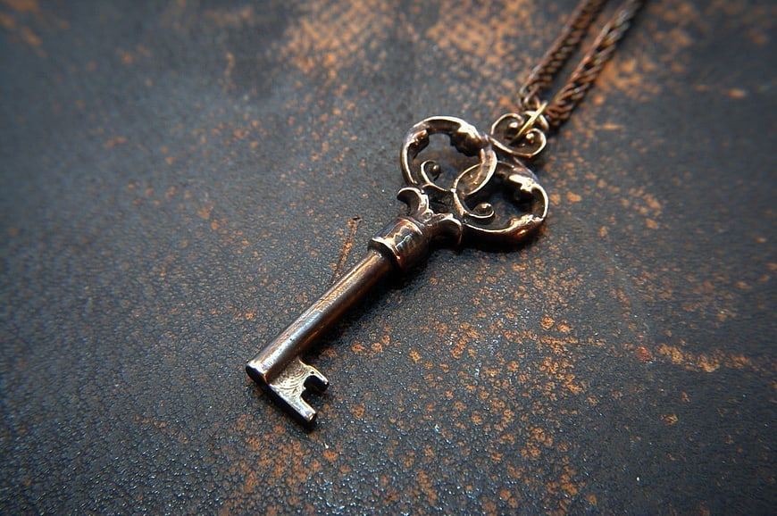 Vintage Skeleton Key Pendant Necklace on Rustic Background