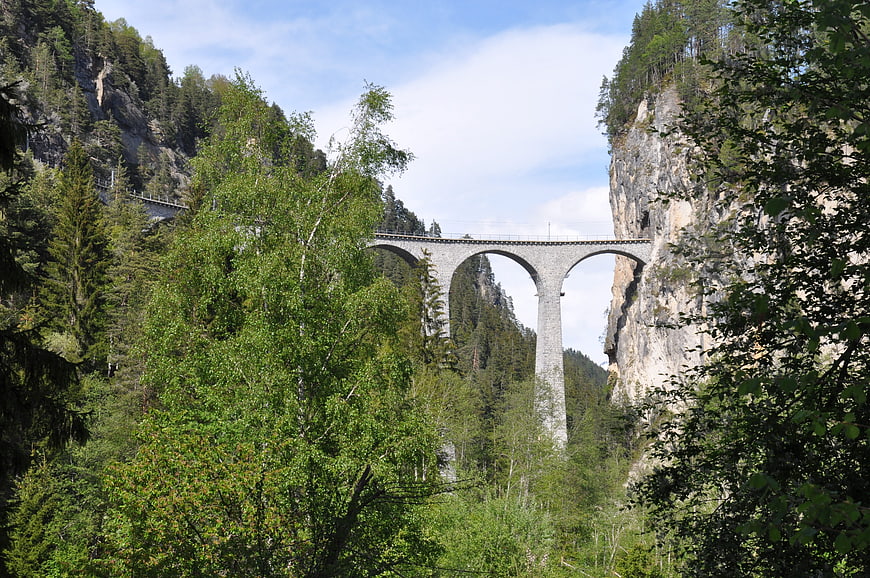 Landwasser Viaduct in Swiss Alps with lush green forest