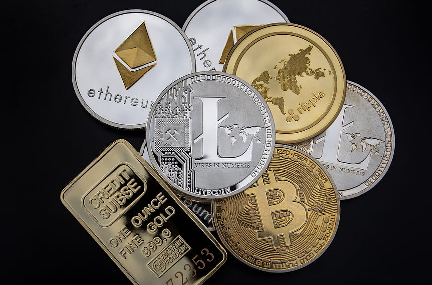 Physical Cryptocurrency Coins and Gold Bar on Black Background