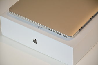 Gold MacBook Pro on White Apple Box