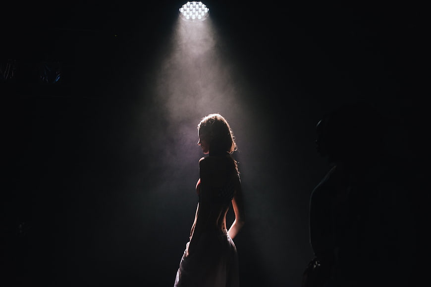 Woman Silhouette in Dramatic Stage Spotlight