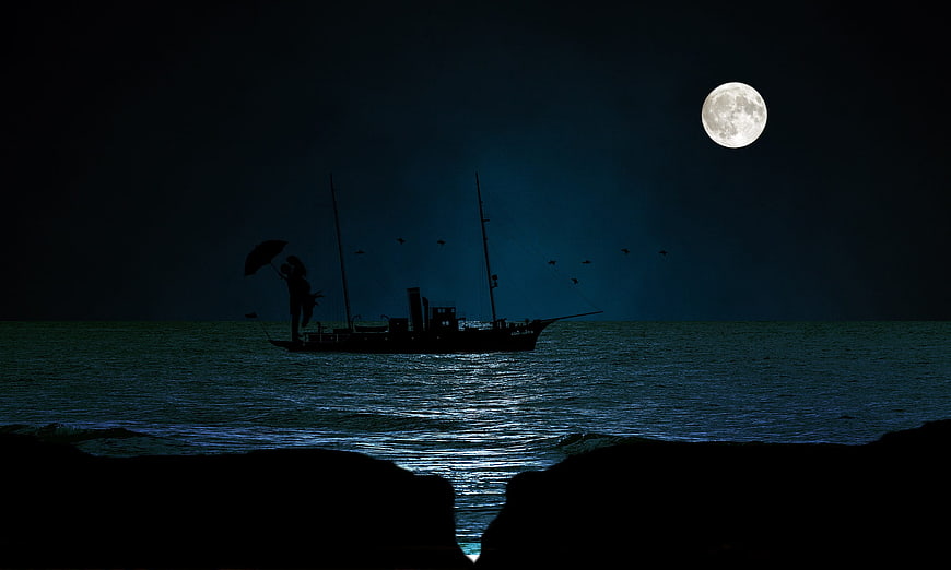 Silhouette of Couple on Boat Under Full Moon at Night