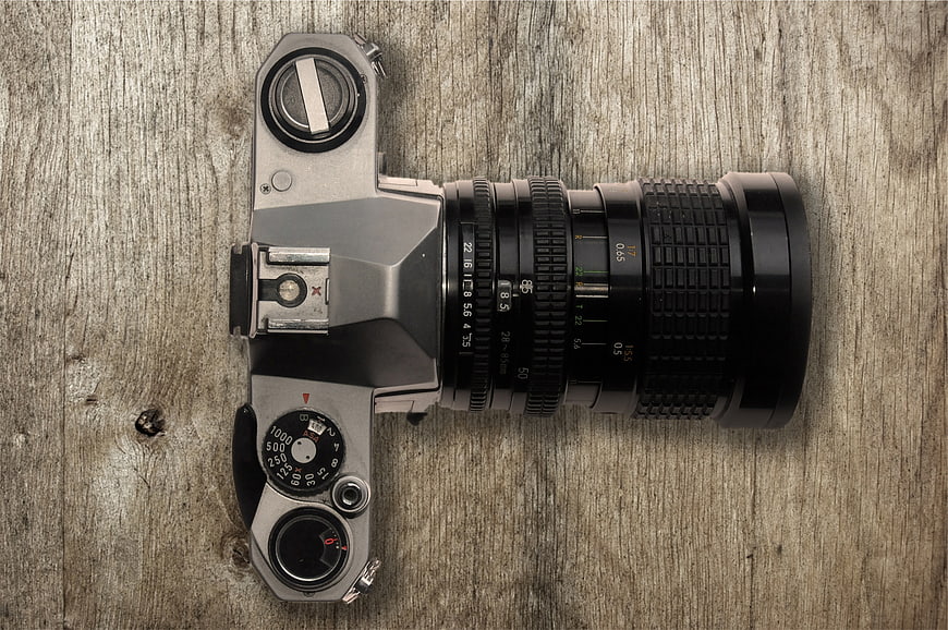 Vintage SLR Camera on Rustic Wooden Background