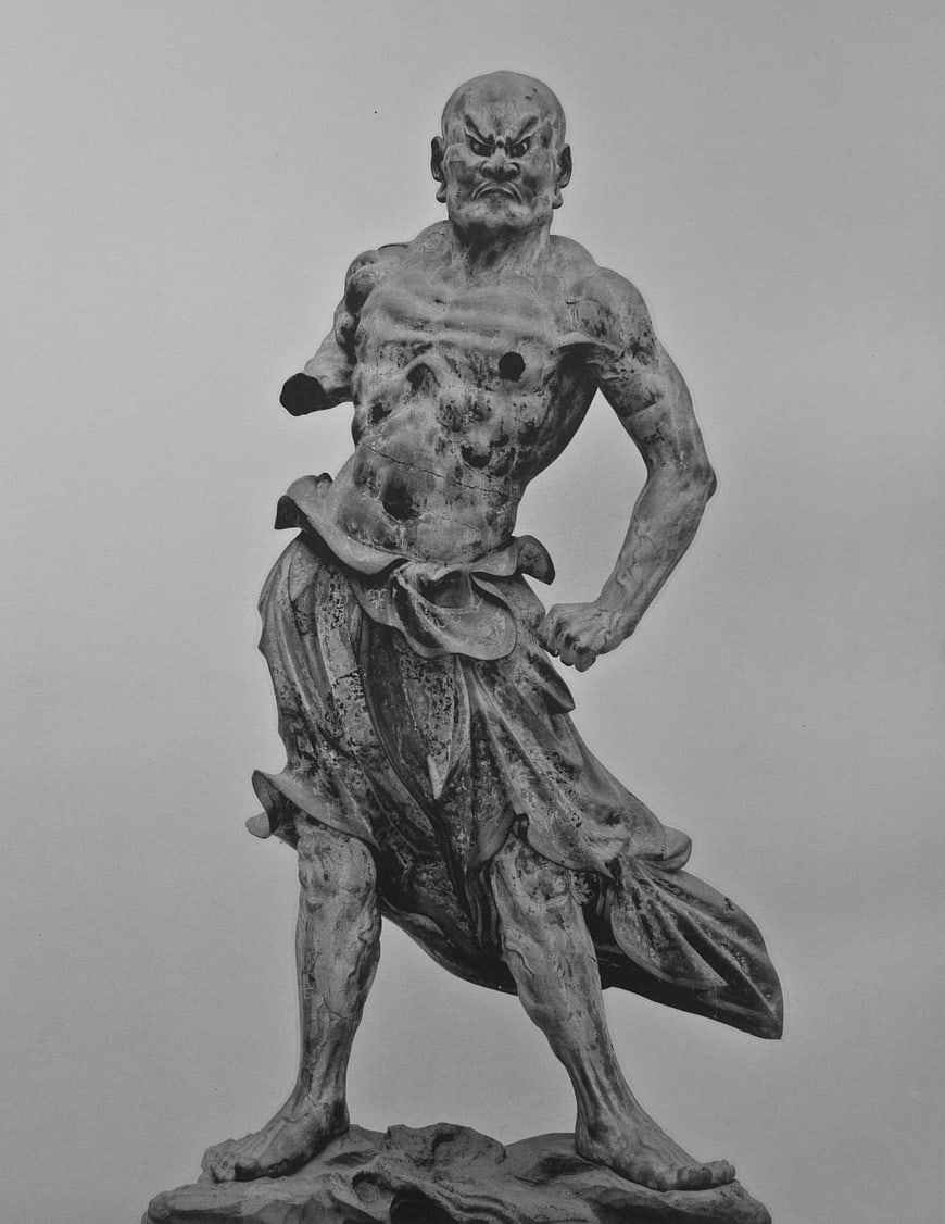 Black and white photo of fierce Buddhist guardian statue