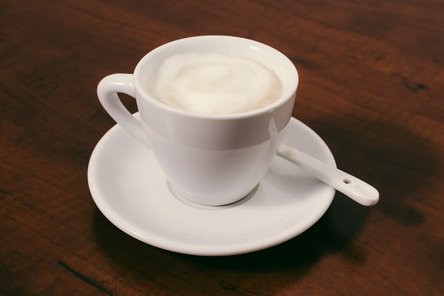 White Cup of Cappuccino on Wooden Table