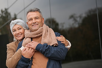 Happy Senior Couple Hugging Outdoors in Autumn