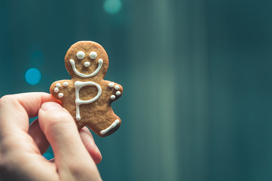Hand holding gingerbread man cookie with letter P
