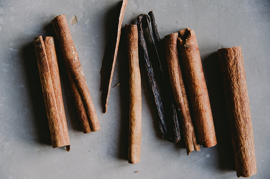 Cinnamon sticks and vanilla beans on gray background