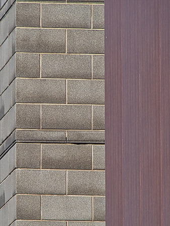 Modern building facade with gray tiles and purple panel