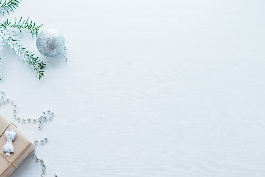 Minimalist Christmas Flat Lay with Gift and Ornament on White Wood