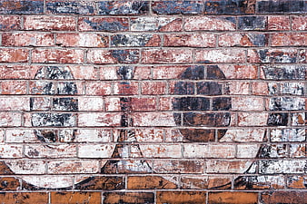Textured Old Brick Wall with Faded Graffiti Pattern