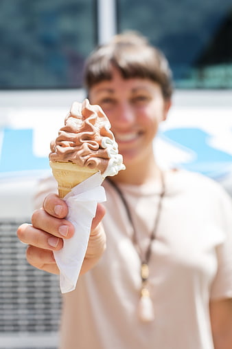 Woman Holding Chocolate and Vanilla Soft Serve Ice Cream Cone