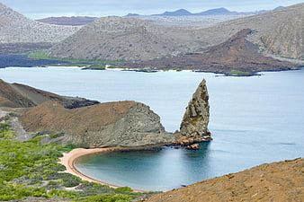 Volcanic Sea Stack And Sandy Cove In The Galapagos Islands