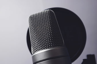 Close-up of professional studio microphone with pop filter