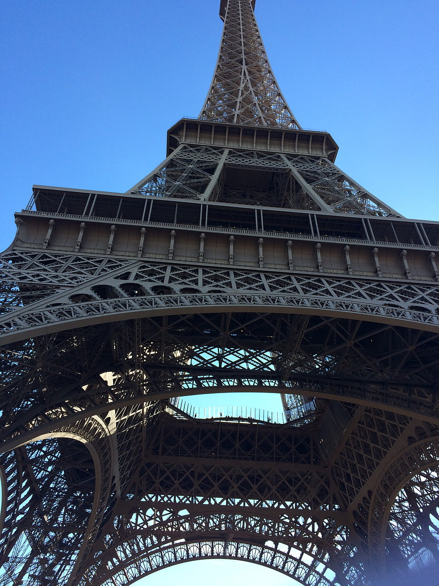 Low angle view of Eiffel Tower iron lattice against blue sky