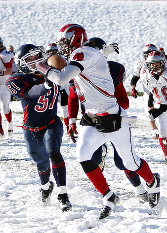American Football Players Tackling in Snow