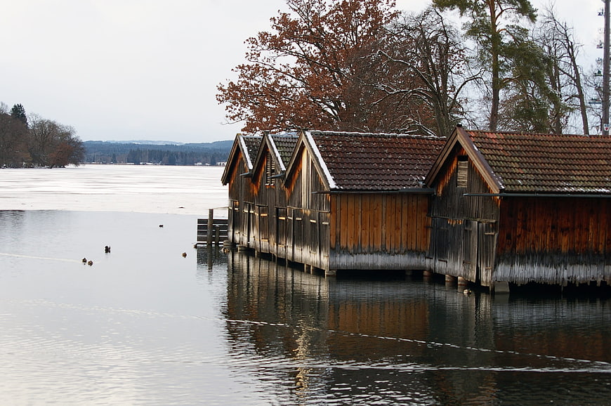 Traditional wooden boat houses on a frozen lake in winter
