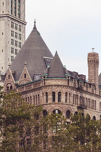 Ornate Historic Stone Building with Conical Roofs and Arched Windows