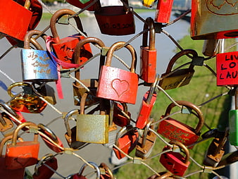 Colorful love locks on bridge fence railing
