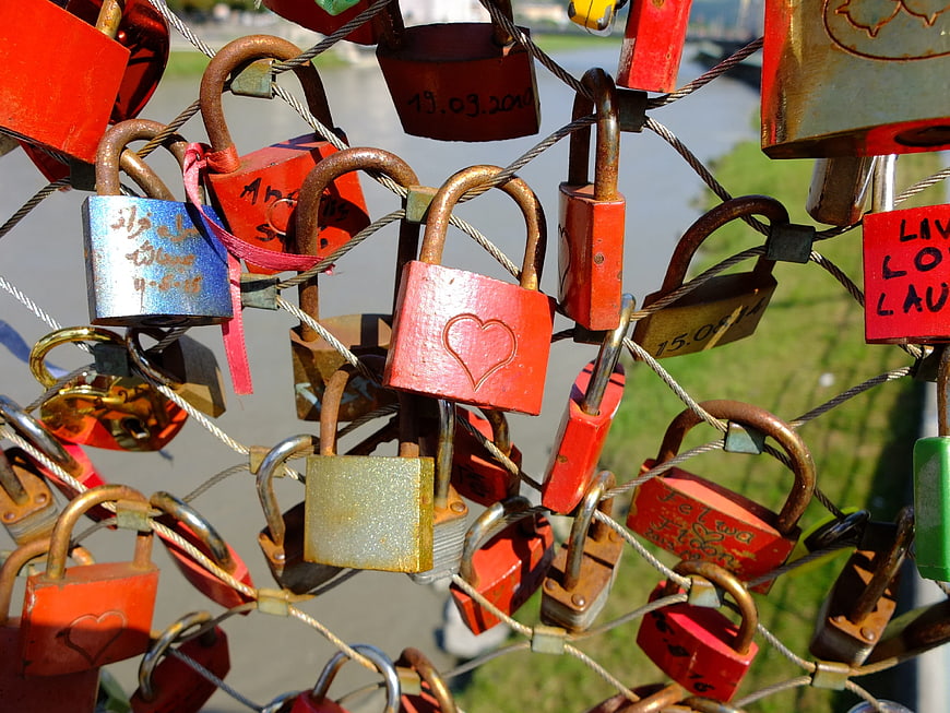 Colorful love locks on bridge fence railing