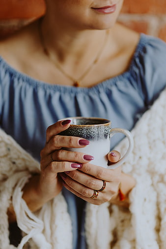 Cozy Woman Holding Ceramic Coffee Mug in Blanket
