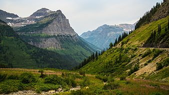 Scenic Mountain Valley with Green Slopes and Rocky Peaks