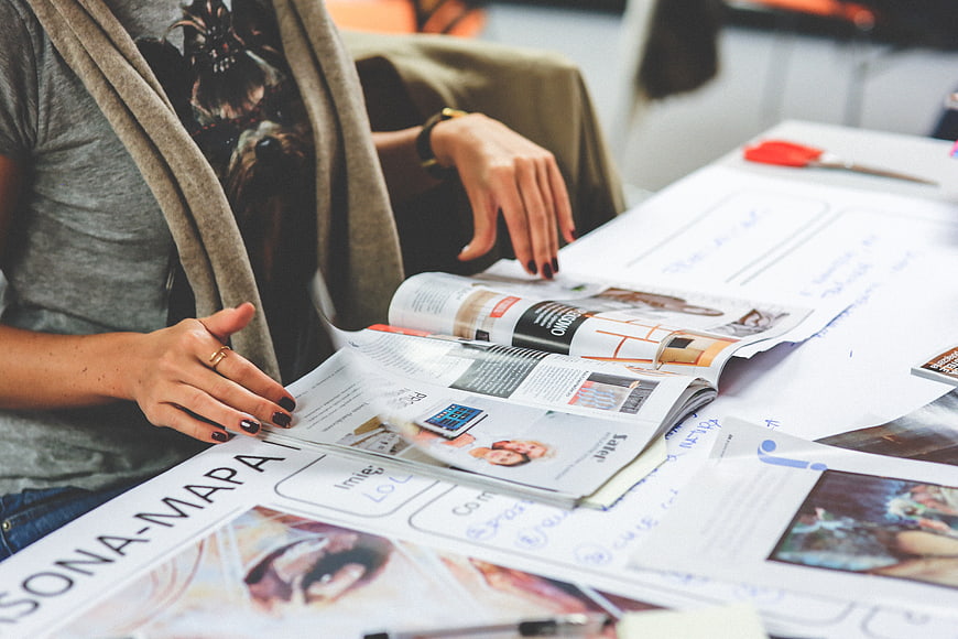 Woman creating persona map with magazine clippings