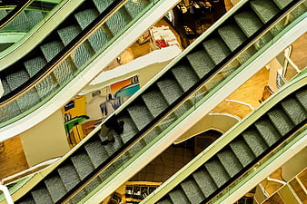 Abstract diagonal view of escalators in a modern shopping mall interior