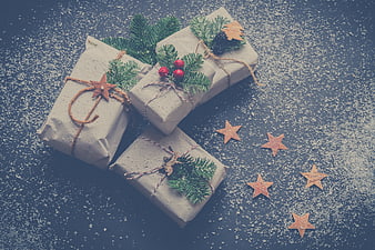 Rustic Christmas gifts wrapped in kraft paper with pine branches