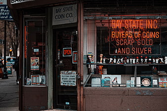 Vintage Coin Shop Exterior with Neon Sign and Collectibles