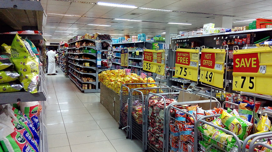 Supermarket Aisle With Promotional Signs And Snack Displays