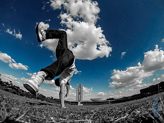 Man performing parkour backflip in Brasilia park